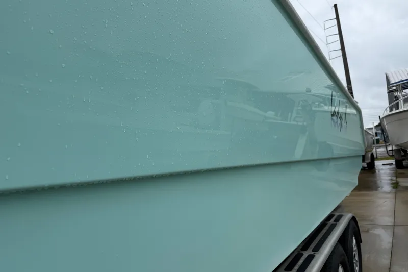 Slide: The Image of Side view of a 2013 Freeman 33 boat with water droplets on the hull. - 83