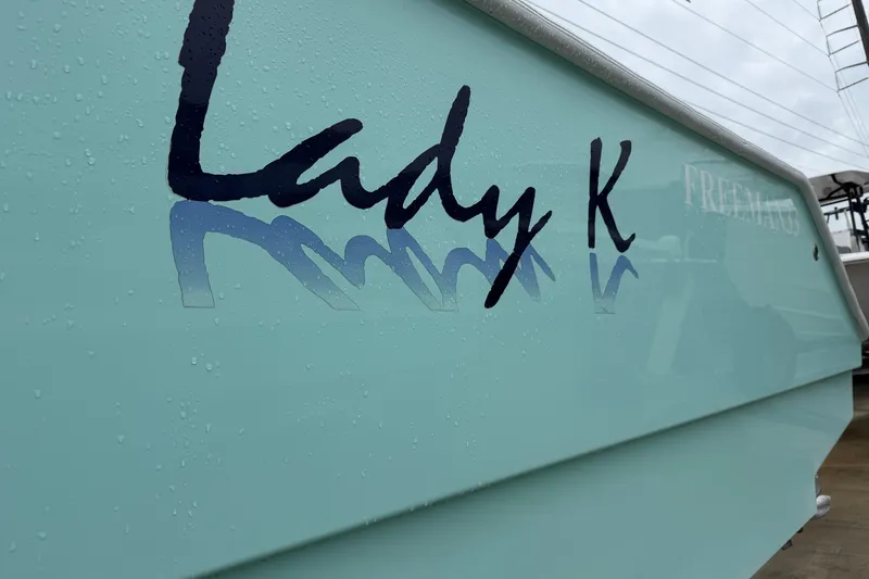 Slide: The Image of Freeman 33 boat, 2013 model, with "Lady K" name on the side, wet surface. - 84