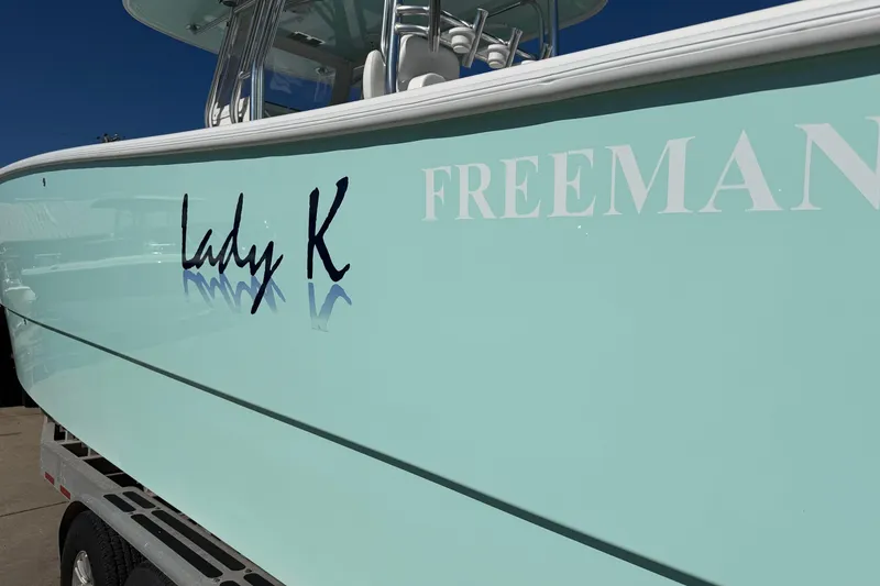Slide: The Image of Freeman 33 boat, 2013 model, with "Lady K" name on light blue hull. - 92