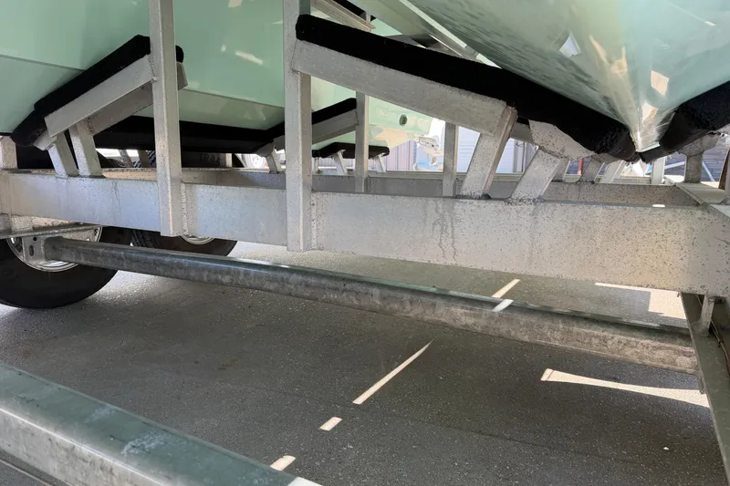 Slide: The Image of Underneath view of a 2013 Freeman 33 boat on a trailer. - 97