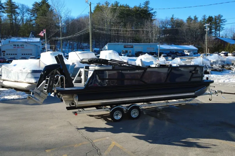 Slide: The Image of 2026 Alera M23Q pontoon boat on trailer in snowy dealership lot. - 6
