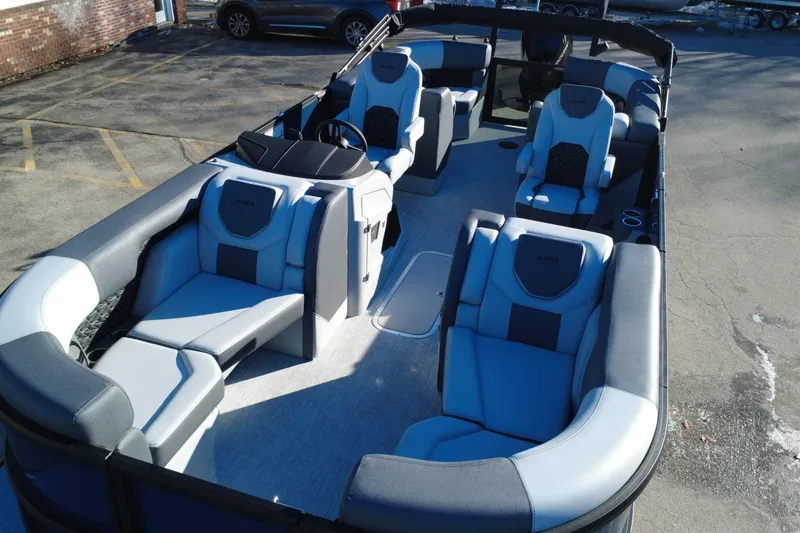 Slide: The Image of 2026 Alera M23Q boat with spacious seating and modern design in a parking lot. - 7