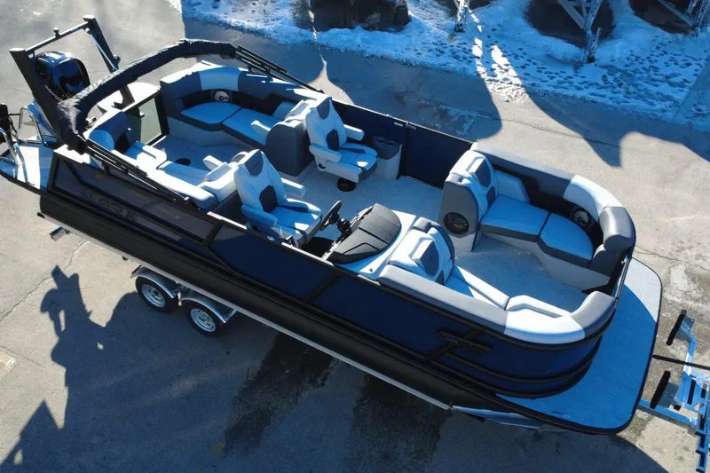 Slide: The Image of Alera M23Q 2026 pontoon boat with luxurious seating, parked on a trailer. - 8