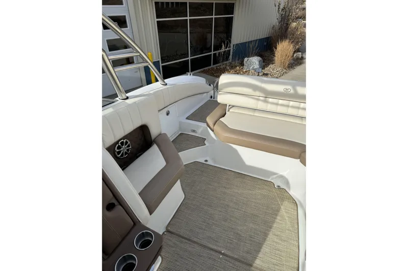 Slide: The Image of Interior of a 2010 Cobalt 276 boat with beige seating and cup holders. - 13