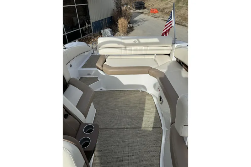 Slide: The Image of 2010 Cobalt 276 boat interior with beige seating and American flag. - 14