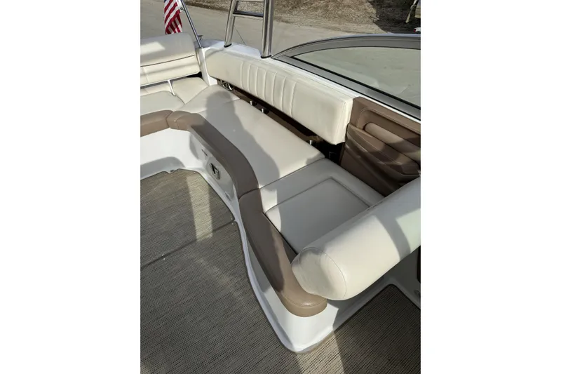 Slide: The Image of 2010 Cobalt 276 boat interior with beige and brown seating. - 16