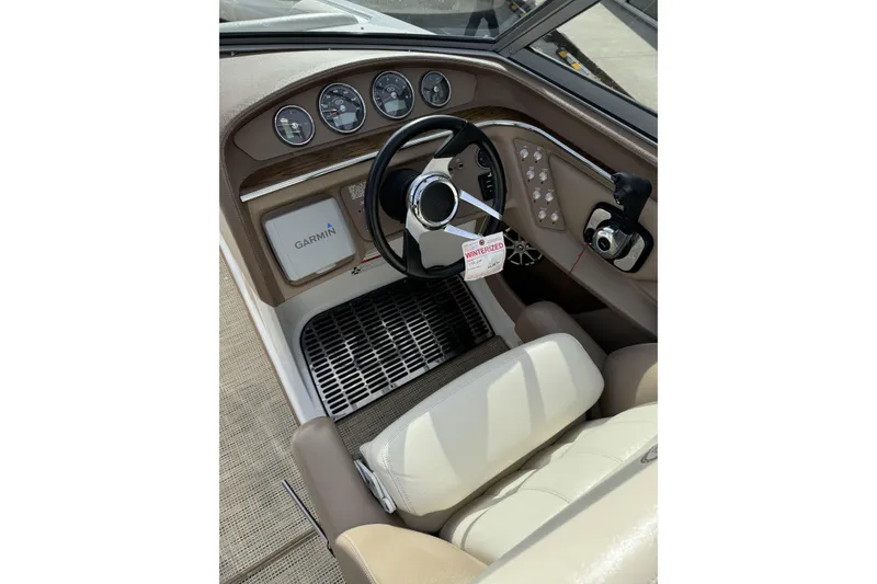 Slide: The Image of Interior of 2010 Cobalt 276 boat with Garmin navigation system and steering wheel. - 17