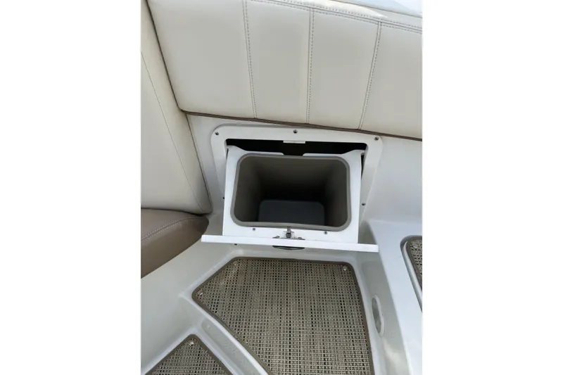 Slide: The Image of 2010 Cobalt 276 boat interior storage compartment with beige seating and woven flooring. - 23