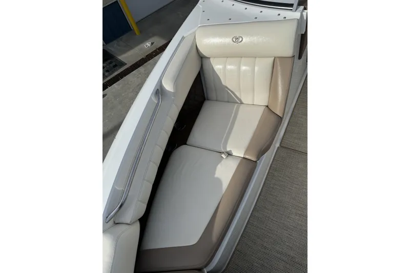 Slide: The Image of 2010 Cobalt 276 boat interior with beige and white leather seating. - 25