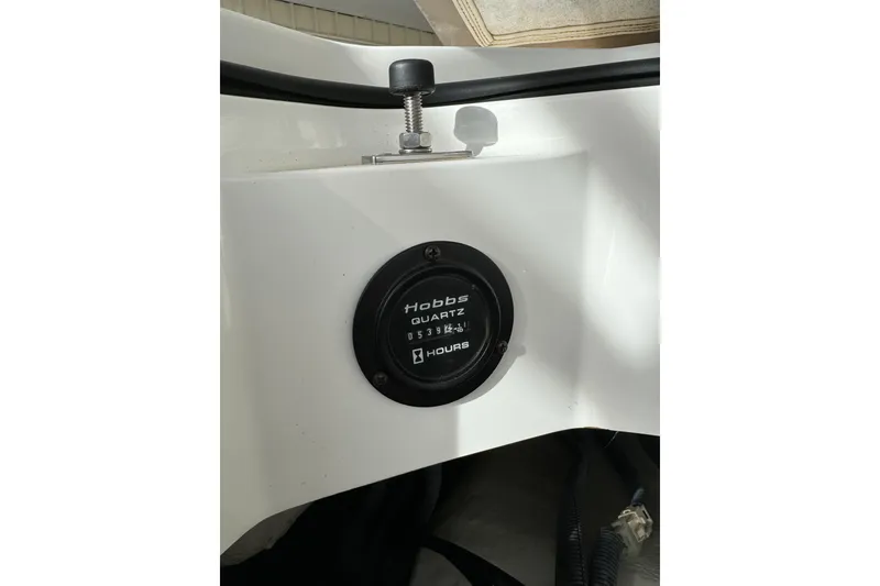 Slide: The Image of Hour meter on 2010 Cobalt 276 boat dashboard, displaying usage hours. - 27