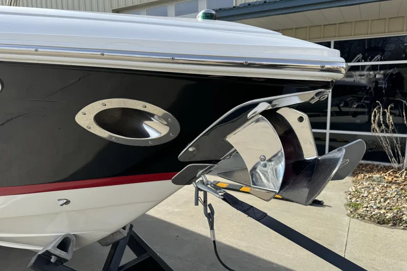 Slide: The Image of 2010 Cobalt 276 boat with stainless steel anchor and sleek black hull design. - 7