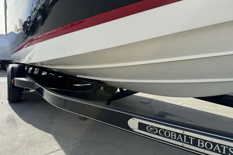 Slide: The Image of 2010 Cobalt 276 boat on trailer, showcasing sleek hull design and branding. - 8