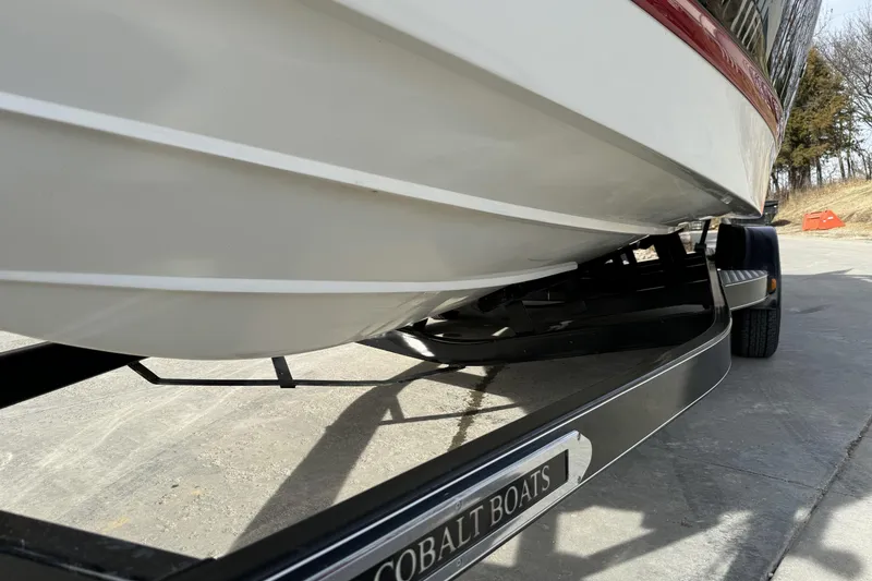 Slide: The Image of 2010 Cobalt 276 boat on trailer, showcasing hull design and branding. - 9