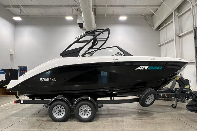 The Image of 2025 Yamaha Boats AR220 on trailer in indoor showroom setting. - 0