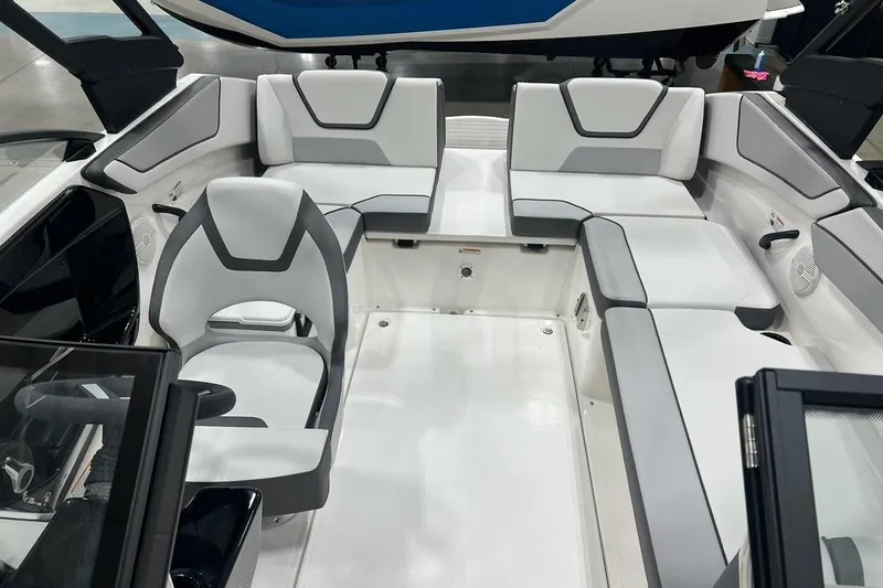 Slide: The Image of Interior of 2025 Yamaha Boats AR220, featuring sleek white and gray seating arrangement. - 5