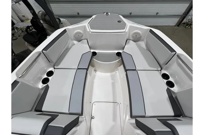 Slide: The Image of 2025 Yamaha Boats AR220 interior with sleek gray seating and cup holders. - 6