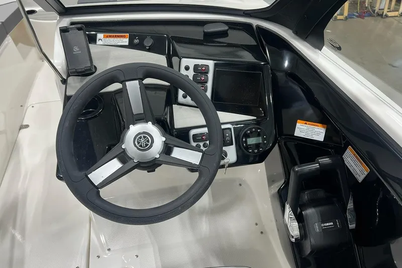 Slide: The Image of 2025 Yamaha Boats AR220 dashboard with steering wheel and control panel. - 7