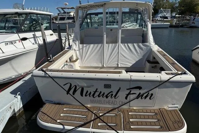 Slide: The Image of 1997 Tiara Yachts 2900 Open boat docked, named "Mutual Fun," in Marblehead, Ohio marina. - 1