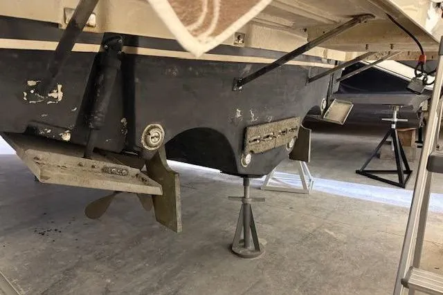 Slide: The Image of 1997 Tiara Yachts 2900 Open boat hull and propeller in dry dock. - 10