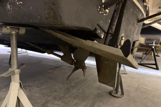 Slide: The Image of 1997 Tiara Yachts 2900 Open propeller and hull on stands in a workshop. - 11