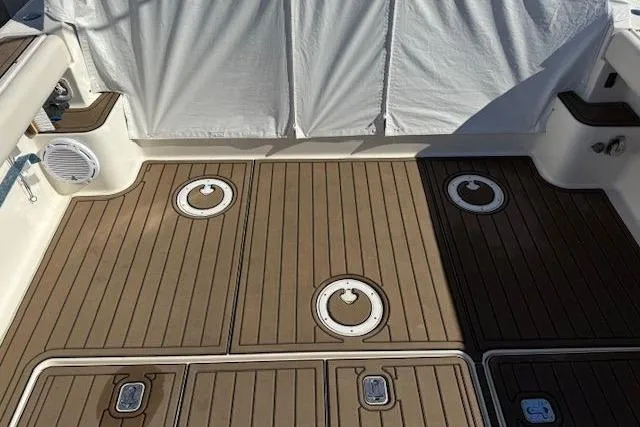 Slide: The Image of 1997 Tiara Yachts 2900 Open deck with teak flooring and storage hatches. - 16