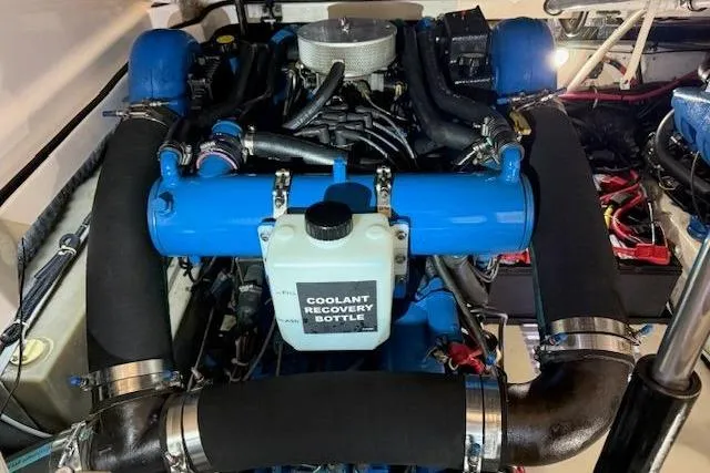 Slide: The Image of Engine compartment of a 1997 Tiara Yachts 2900 Open, featuring a coolant recovery bottle. - 19