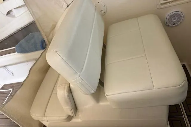 Slide: The Image of 1997 Tiara Yachts 2900 Open interior seating with white upholstery and speaker detail. - 24