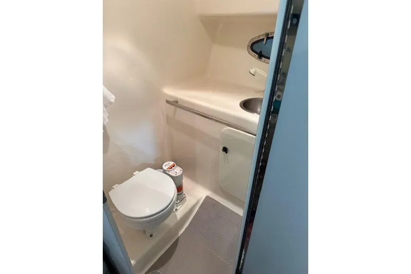 Slide: The Image of Compact bathroom in 1997 Tiara Yachts 2900 Open, featuring toilet and sink. - 26