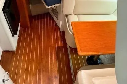 Slide: The Image of 1997 Tiara Yachts 2900 Open interior with wood flooring and cushioned seating. - 28