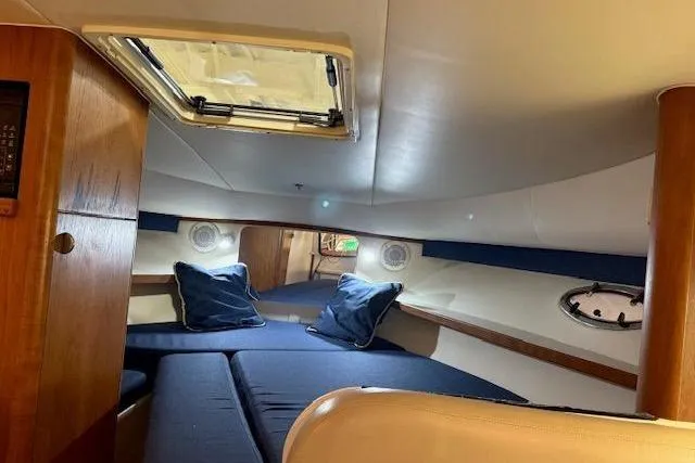 Slide: The Image of Interior cabin of 1997 Tiara Yachts 2900 Open, featuring cozy seating and porthole. - 29