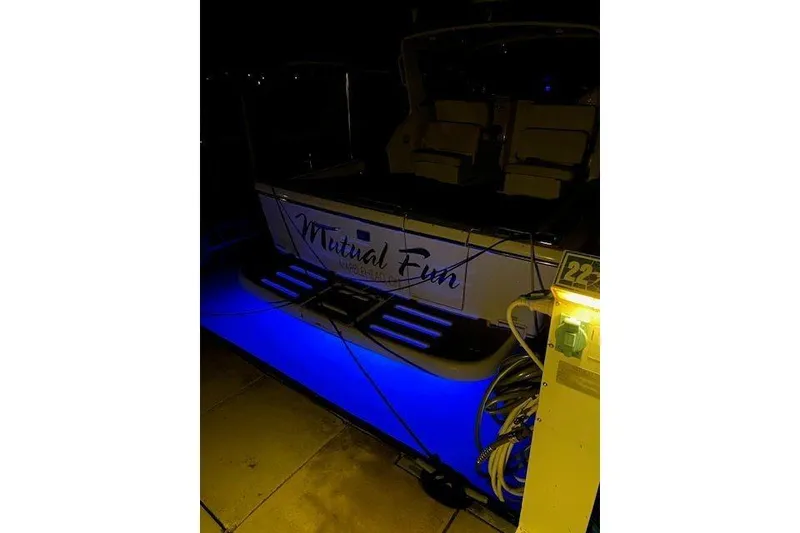 Slide: The Image of 1997 Tiara Yachts 2900 Open with blue underwater lights at night. - 5