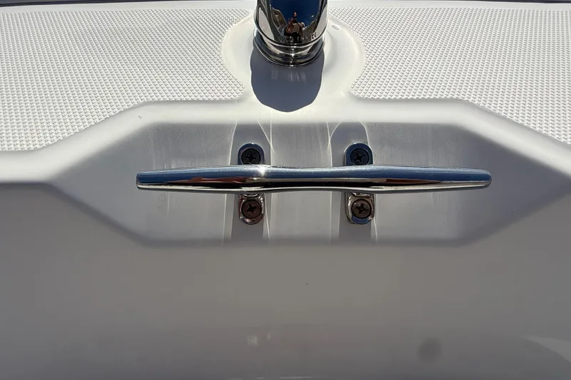 Slide: The Image of 2018 Boston Whaler 170 Super Sport boat with outboard motor, parked near a white fence. - 10