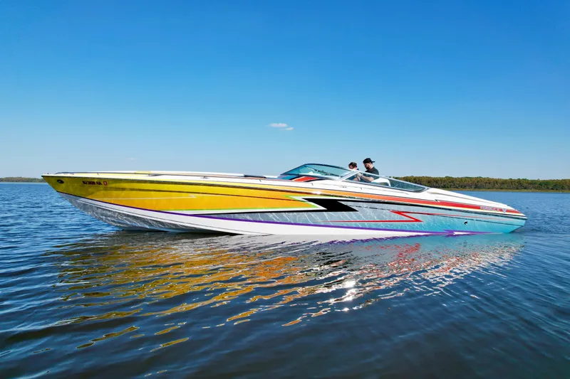 The Image of 2006 Formula 382 FASTech speedboat with vibrant graphics cruising on a calm lake. - 1