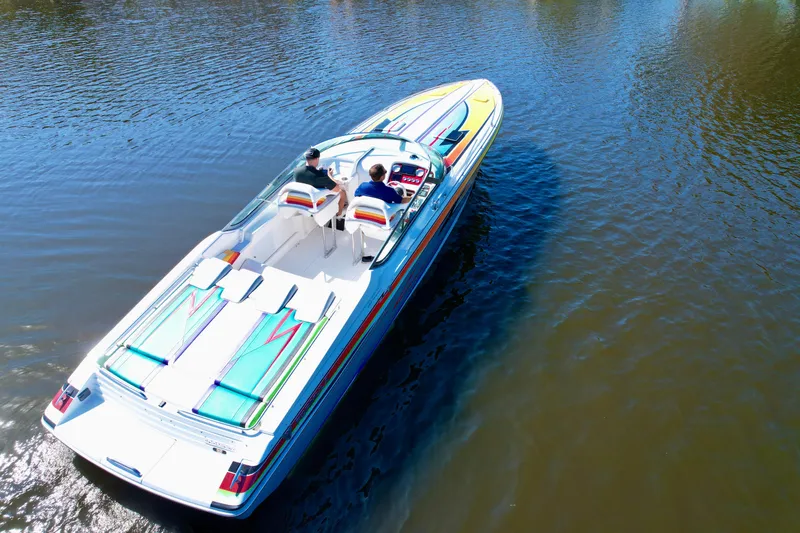 Slide: The Image of 2006 Formula 382 FASTech speedboat cruising on calm water, featuring vibrant graphics. - 9