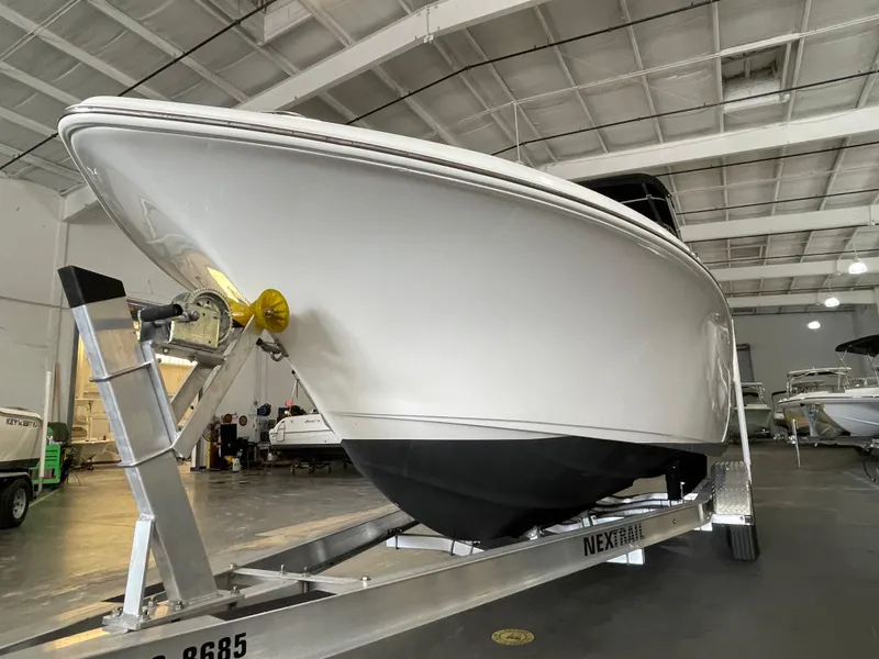 Slide: The Image of 2022 Key West 239 DFS boat with Yamaha 250 engine, parked outdoors. - 10