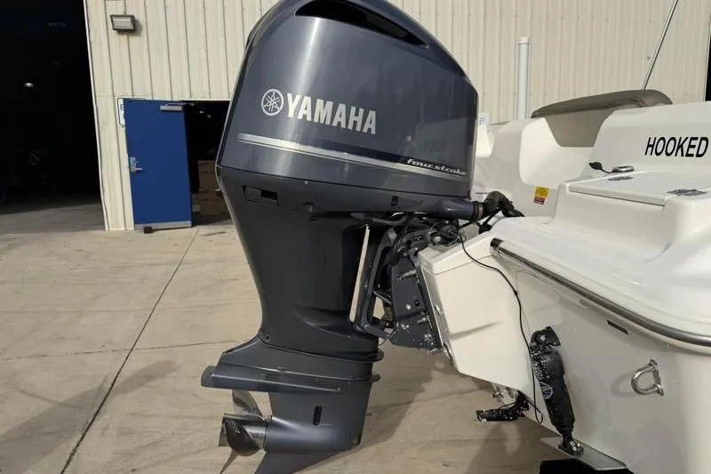 Slide: The Image of 2022 Key West 239 DFS boat with Yamaha outboard motor in a marina setting. - 13