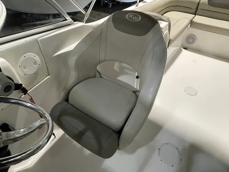Slide: The Image of 2022 Key West 239 DFS boat interior with gray seat and storage compartment. - 27