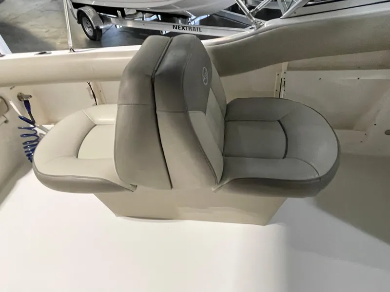 Slide: The Image of 2022 Key West 239 DFS boat interior with beige cushioned seating. - 31