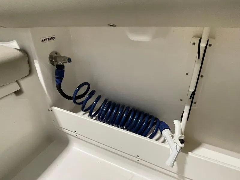 Slide: The Image of 2022 Key West 239 DFS boat storage compartment with secure latch and clean design. - 34