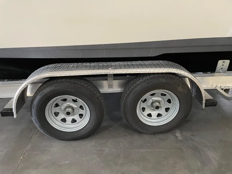 Slide: The Image of Trailer wheels of a 2022 Key West 239 DFS boat on a concrete surface. - 38