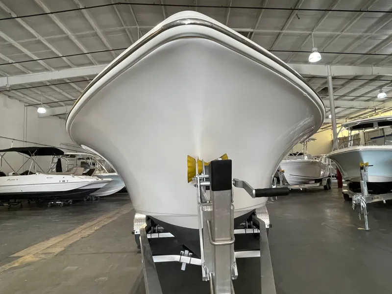 Slide: The Image of 2022 Key West 239 DFS boat on trailer, parked near a beige building. - 8