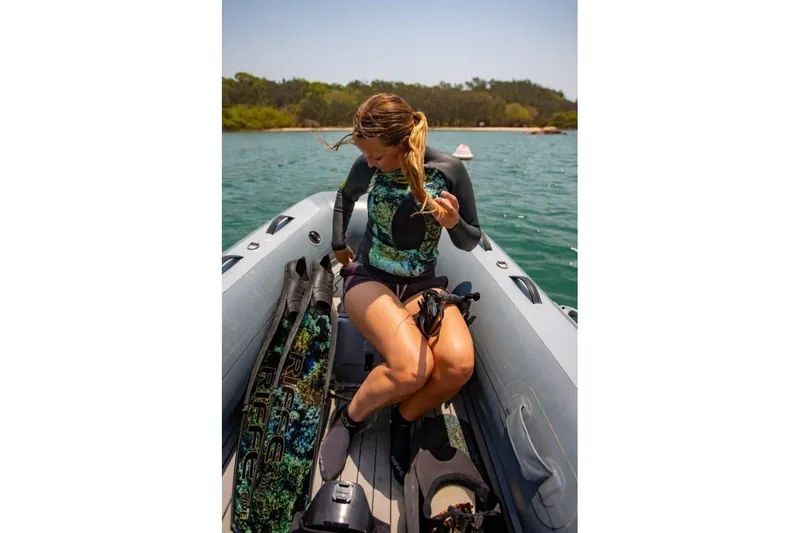 Slide: The Image of Woman on Highfield Classic 340 boat, 2026 model, with diving gear. - 9