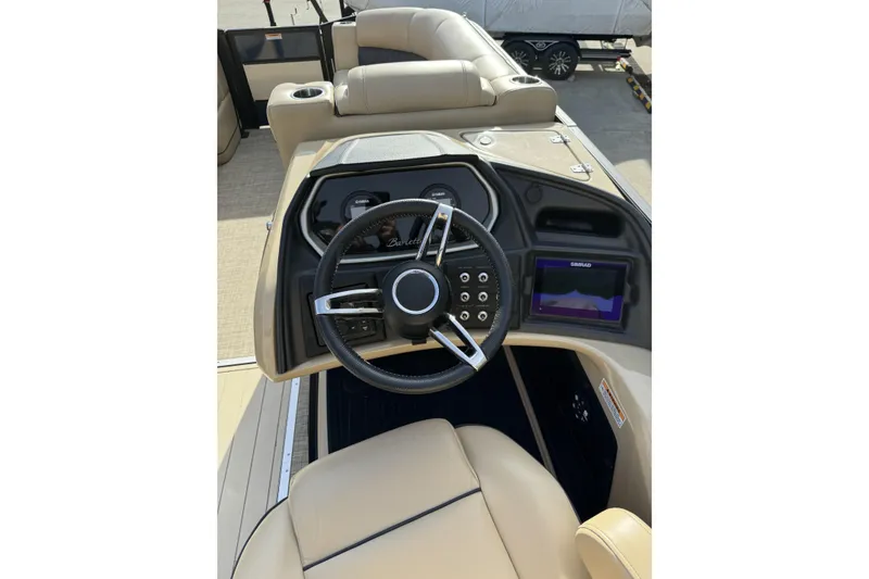 Slide: The Image of 2019 Barletta L23QC SS boat dashboard with steering wheel and navigation display. - 15