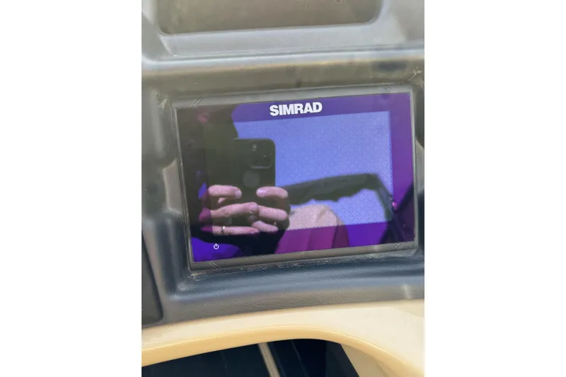 Slide: The Image of Simrad display on 2019 Barletta L23QC SS boat dashboard, reflecting surroundings. - 16