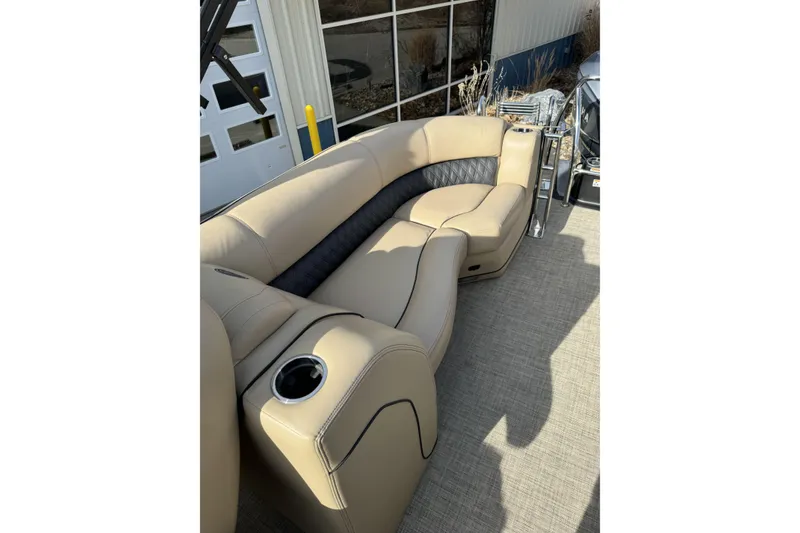 Slide: The Image of 2019 Barletta L23QC SS boat interior with beige seating and cup holder. - 21