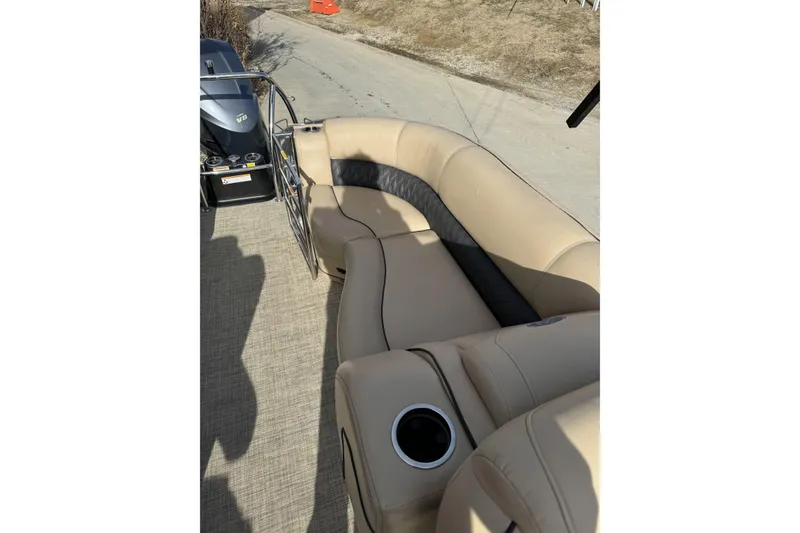 Slide: The Image of 2019 Barletta L23QC SS boat interior with beige seating and cup holder. - 22