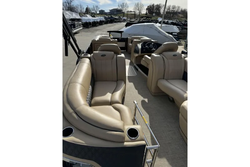 Slide: The Image of 2019 Barletta L23QC SS pontoon boat with beige seating and spacious interior. - 23