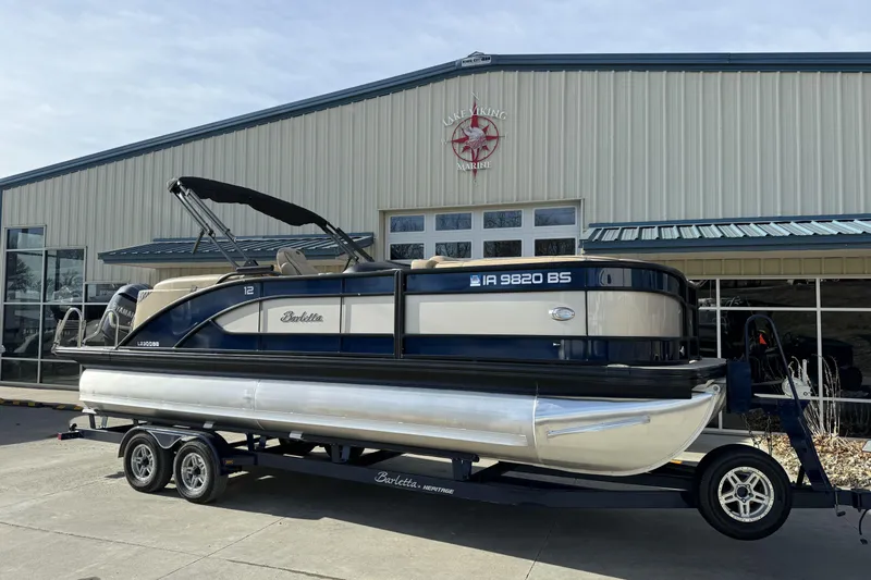 Slide: The Image of 2019 Barletta L23QC SS pontoon boat on trailer outside Lake Viking Marine building. - 7