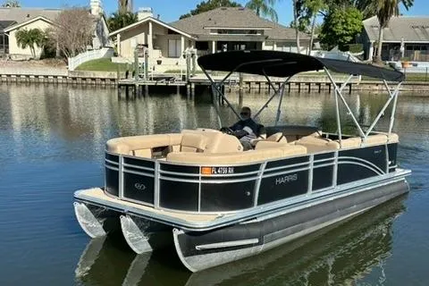 The Image of 2017 Harris Cruiser 220 pontoon boat on a calm residential waterway. - 0