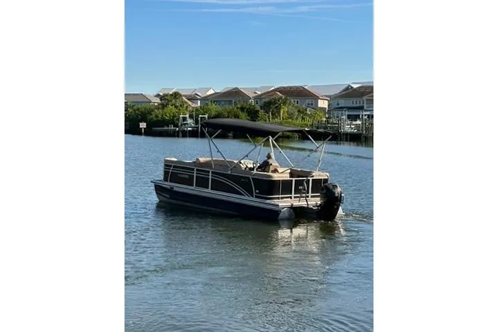 Slide: The Image of 2017 Harris Cruiser 220 pontoon boat on a calm waterway near residential area. - 10